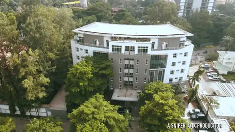 Aerial frame of a hotel among trees, from a wedding film.