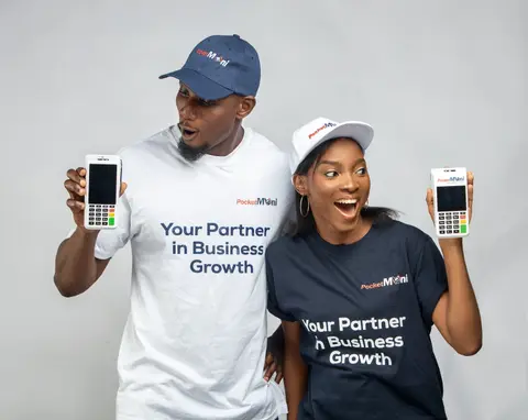A man and a woman in PocketMoni tees each hold up a terminal.